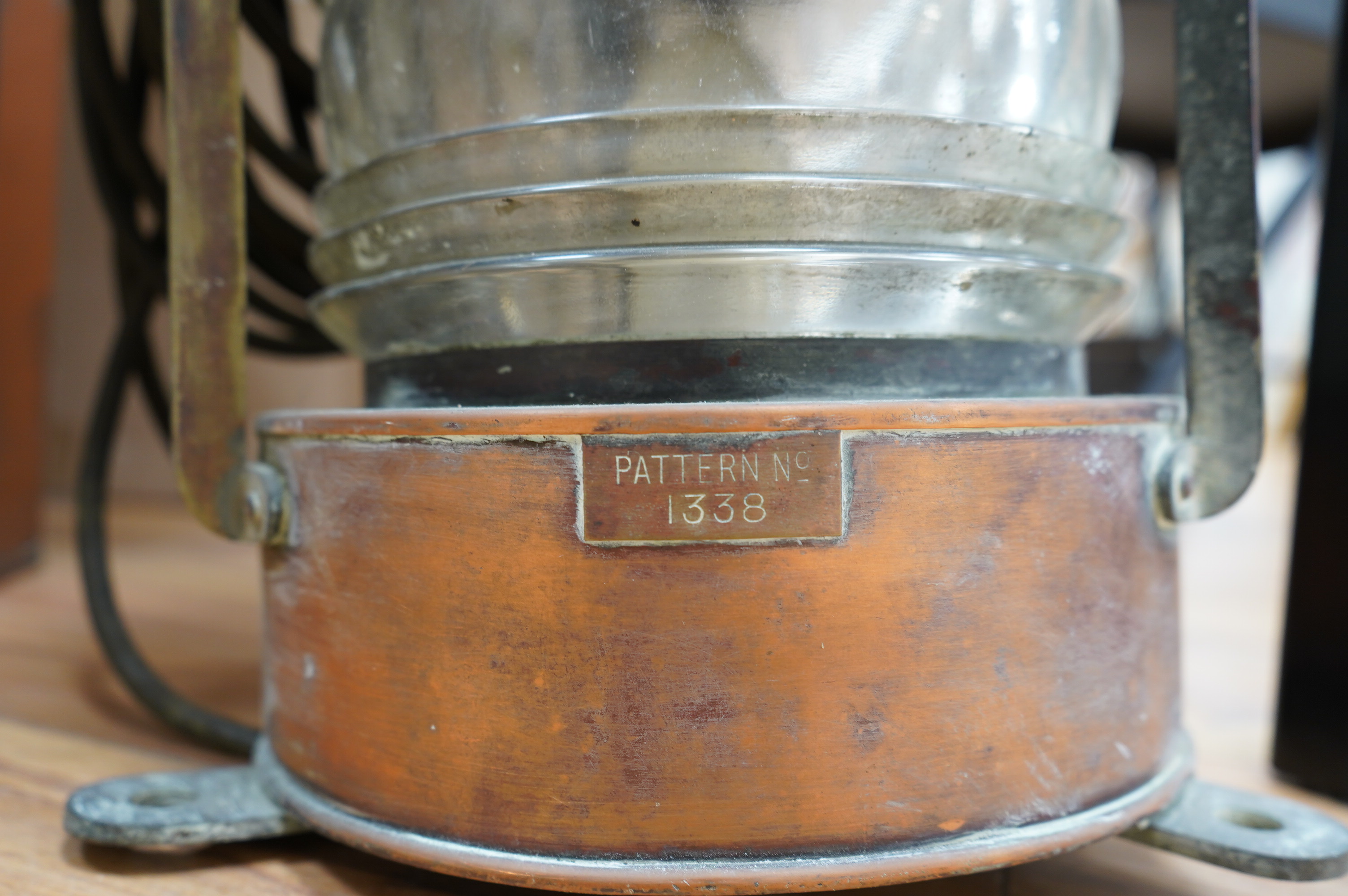 An early 20th century ship’s copper mast head lamp, and another copper ship’s lamp, largest 69cm high. Condition - fair